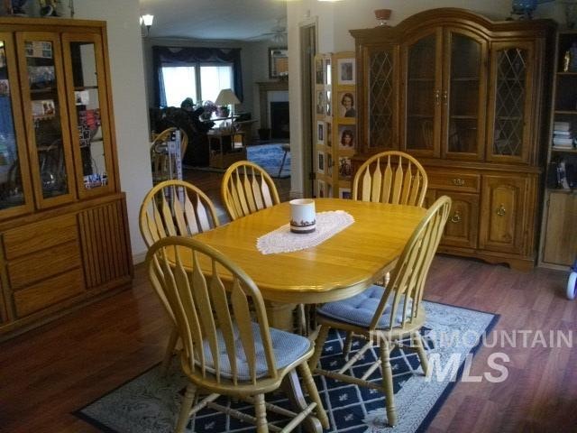 dining area featuring wood finished floors and a fireplace