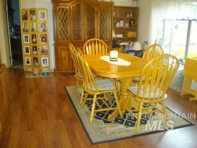 dining room with dark hardwood / wood-style flooring