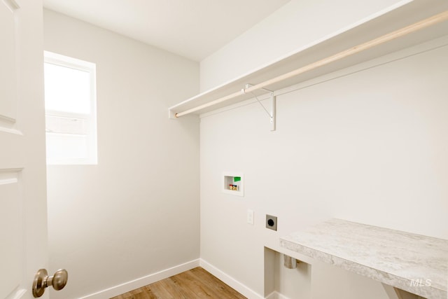 laundry room featuring baseboards, laundry area, electric dryer hookup, washer hookup, and light wood-style floors