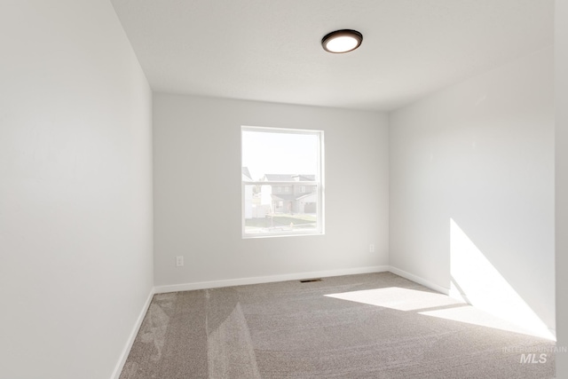 unfurnished room featuring visible vents, baseboards, and carpet floors