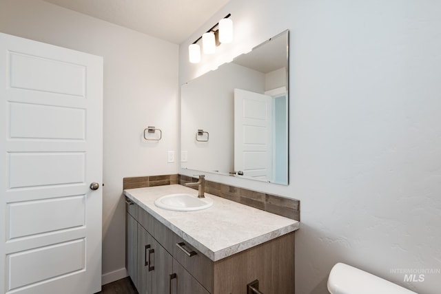 half bathroom featuring toilet and vanity