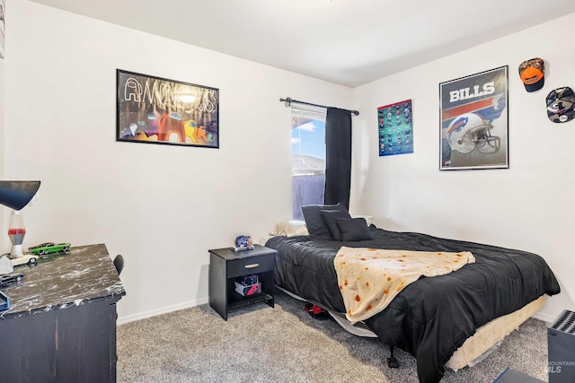 bedroom featuring light carpet and baseboards