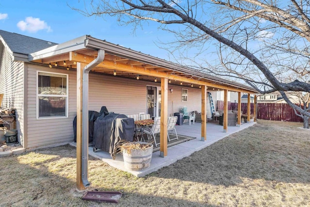 back of house featuring a yard, a patio area, and fence