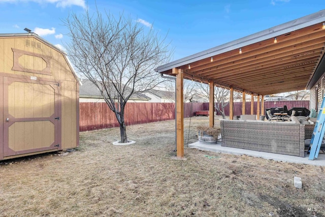 view of yard featuring a fenced backyard, an outdoor structure, an outdoor hangout area, and a storage unit