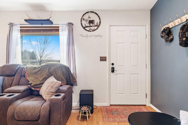 foyer entrance featuring light wood-style flooring and baseboards