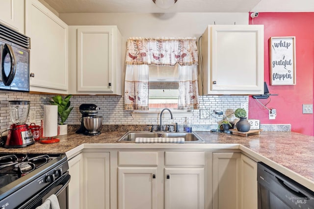 kitchen with black appliances, backsplash, a sink, and white cabinetry