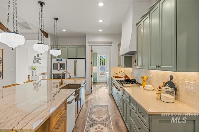 25580 Gooseberry Ln, Caldwell, ID 83607 - kitchen featuring white appliances, light wood finished floors, a spacious island, recessed lighting, and decorative backsplash