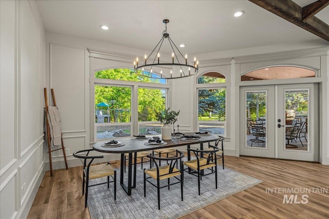 25580 Gooseberry Ln, Caldwell, ID 83607 - dining area with a decorative wall, a chandelier, wood finished floors, french doors, and recessed lighting