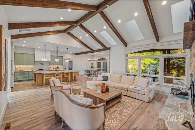 25580 Gooseberry Ln, Caldwell, ID 83607 - living room featuring recessed lighting, light wood finished floors, beam ceiling, high vaulted ceiling, and a chandelier