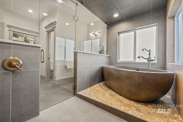 25580 Gooseberry Ln, Caldwell, ID 83607 - full bathroom with a sink, a freestanding tub, tile patterned flooring, tile walls, and a shower stall