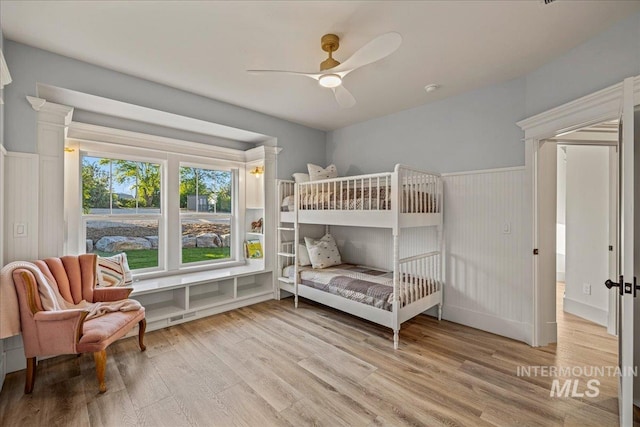 25580 Gooseberry Ln, Caldwell, ID 83607 - bedroom featuring wood finished floors, wainscoting, and a ceiling fan
