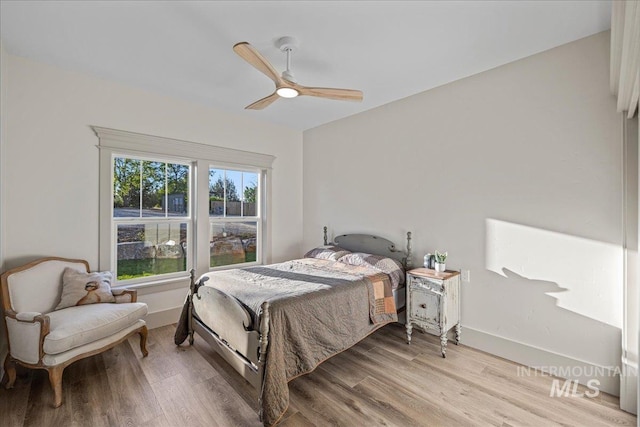 25580 Gooseberry Ln, Caldwell, ID 83607 - bedroom with wood finished floors, a ceiling fan, and baseboards
