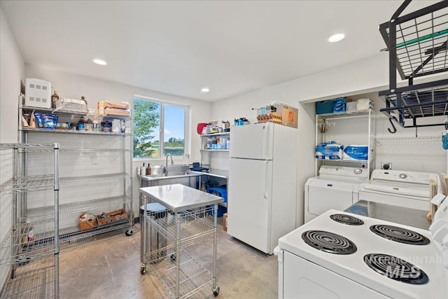 25580 Gooseberry Ln, Caldwell, ID 83607 - kitchen with white appliances, a sink, concrete floors, washing machine and dryer, and recessed lighting