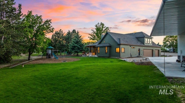25580 Gooseberry Ln, Caldwell, ID 83607 - back of property featuring driveway, a playground, a lawn, a garage, and a chimney