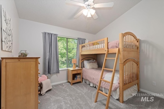 carpeted bedroom featuring baseboards and a ceiling fan