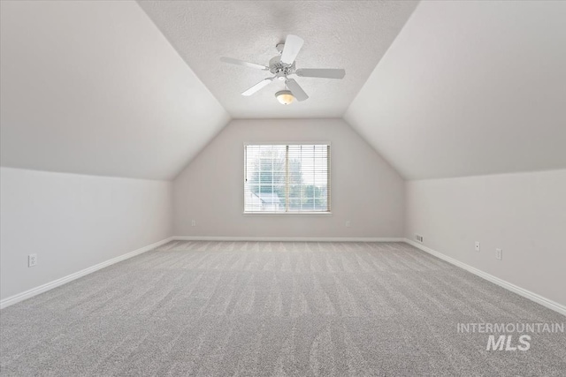 bonus room with baseboards, ceiling fan, carpet flooring, and lofted ceiling