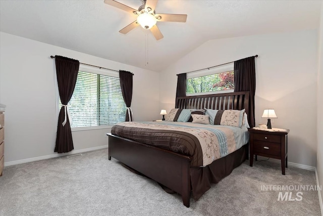 bedroom featuring baseboards, multiple windows, carpet floors, and lofted ceiling