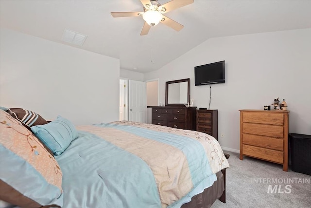 bedroom featuring visible vents, baseboards, light colored carpet, a ceiling fan, and vaulted ceiling