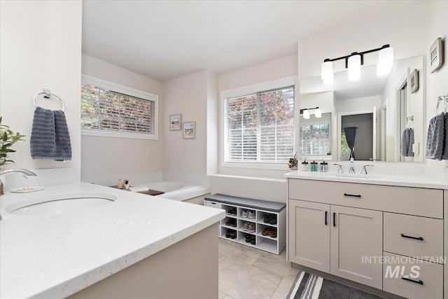 full bathroom featuring a sink and two vanities