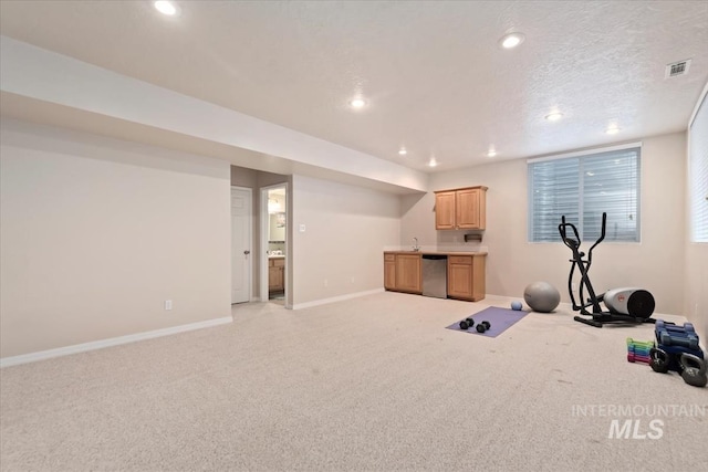exercise room featuring recessed lighting, baseboards, visible vents, and light carpet