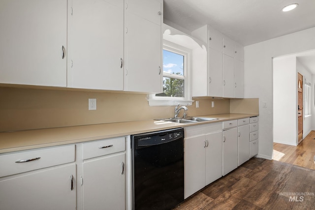 kitchen with a sink, white cabinetry, wood finished floors, and dishwasher