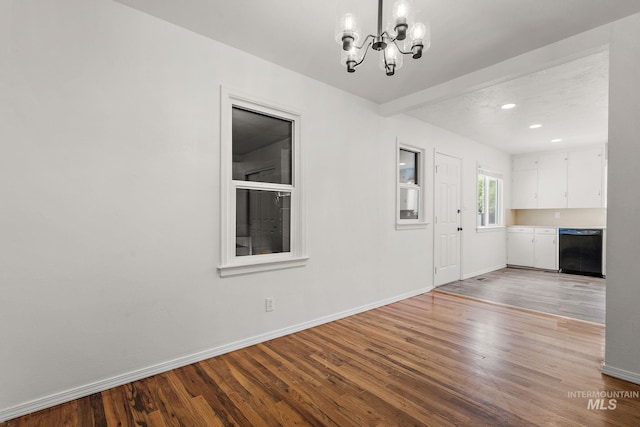 interior space with recessed lighting, baseboards, a notable chandelier, and wood finished floors