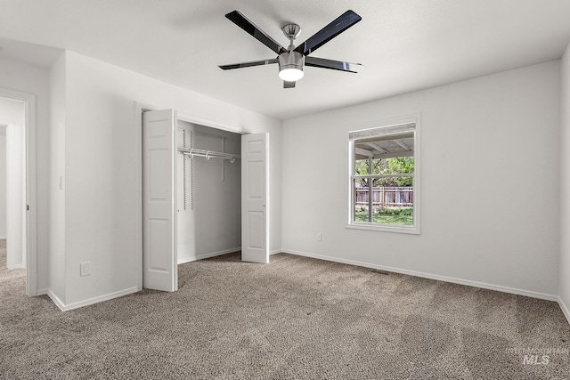 unfurnished bedroom with carpet floors, baseboards, ceiling fan, and a closet