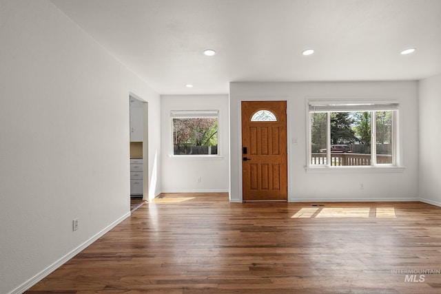 entryway with plenty of natural light, recessed lighting, baseboards, and wood finished floors