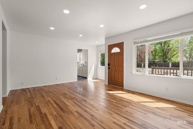 entryway with recessed lighting, baseboards, wood finished floors, and visible vents