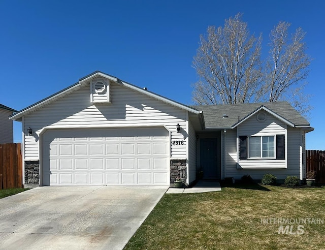 ranch-style house featuring fence, concrete driveway, stone siding, a front yard, and a garage
