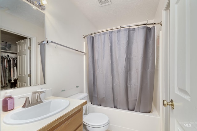 bathroom featuring a textured ceiling, vanity, shower / tub combo, toilet, and visible vents