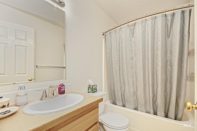 full bath featuring a textured ceiling, shower / tub combo, toilet, and vanity