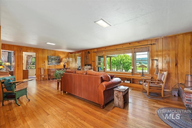 living room with light hardwood / wood-style floors and a textured ceiling