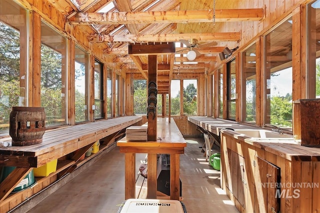 unfurnished sunroom with sink and ceiling fan