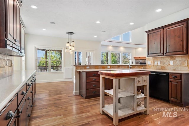 kitchen featuring open shelves, a peninsula, black dishwasher, light wood finished floors, and backsplash