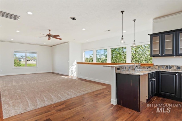 kitchen featuring a sink, recessed lighting, baseboards, a ceiling fan, and visible vents