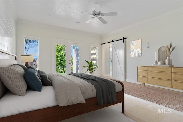 carpeted bedroom featuring crown molding, access to outside, a barn door, a ceiling fan, and baseboards