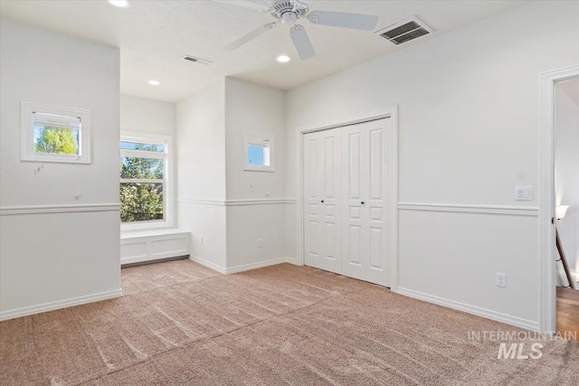 unfurnished bedroom with carpet, recessed lighting, baseboards, visible vents, and a closet
