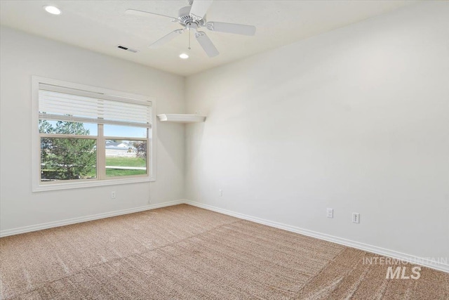 empty room with baseboards, carpet, recessed lighting, and visible vents
