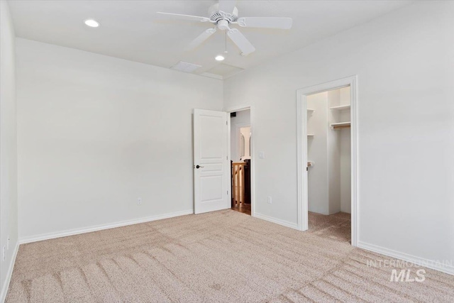 unfurnished bedroom with carpet flooring, recessed lighting, baseboards, and a spacious closet