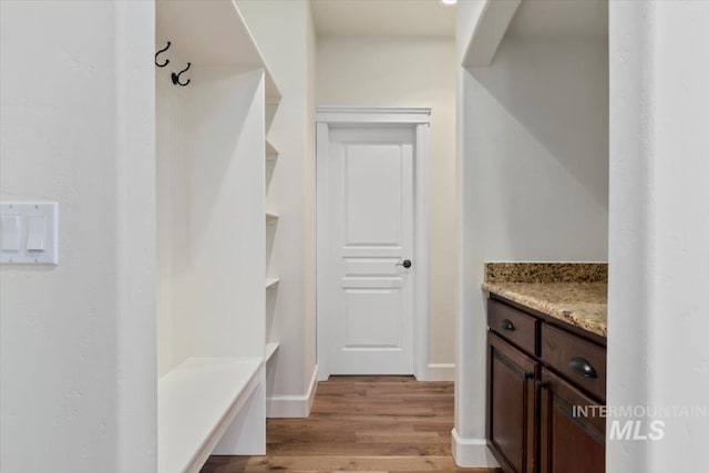 mudroom featuring baseboards and light wood finished floors