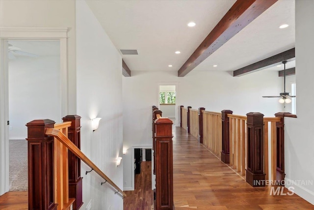 corridor featuring visible vents, recessed lighting, an upstairs landing, and beamed ceiling