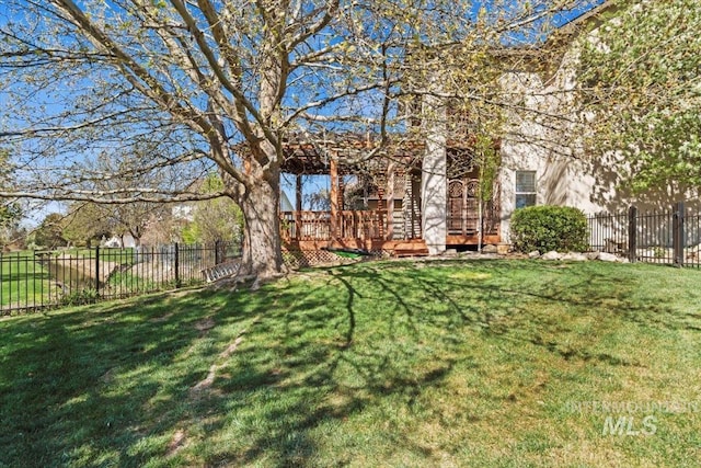 view of yard with a wooden deck and fence private yard