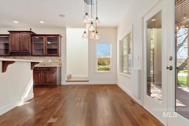 unfurnished dining area featuring recessed lighting, baseboards, visible vents, and wood finished floors