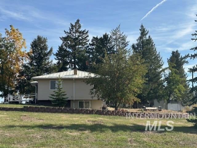 view of side of property with a yard