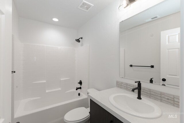 206 Marble Ave, Caldwell, ID 83605 - bathroom featuring vanity, toilet, bathing tub / shower combination, and recessed lighting