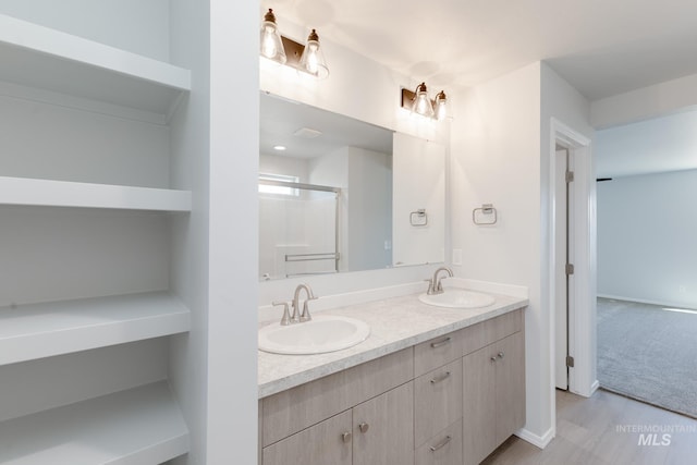 206 Marble Ave, Caldwell, ID 83605 - bathroom with double vanity, a shower with shower door, and wood finished floors