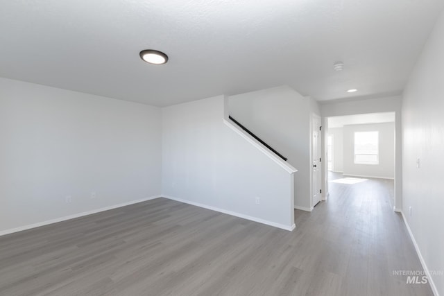 206 Marble Ave, Caldwell, ID 83605 - unfurnished living room with wood finished floors, baseboards, and stairway