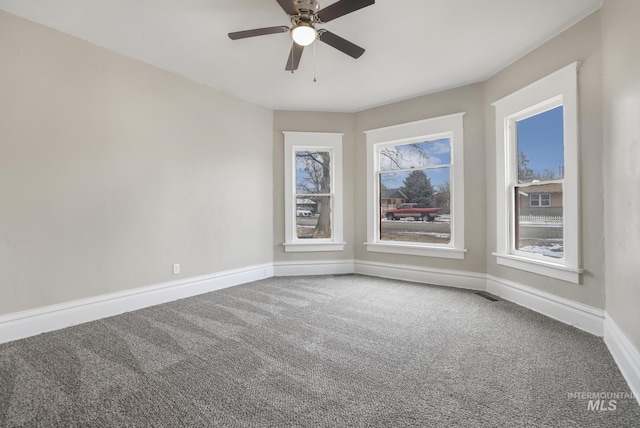 empty room with carpet flooring and ceiling fan