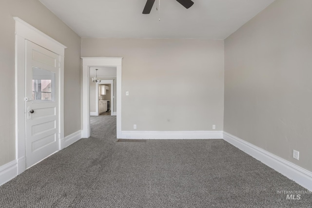 empty room featuring ceiling fan and carpet